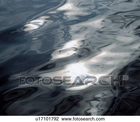 Stock Image - Light reflecting on water. Fotosearch
