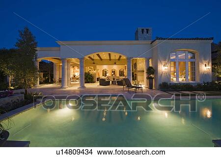 Picture - Lit swimming pool and building exterior. Fotosearch