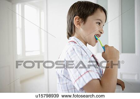 Stock Photo - Little Boy Brushing Teeth in bathroom. Fotosearch