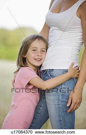 Stock Image - Little Girl Hugging Her Mother. Fotosearch