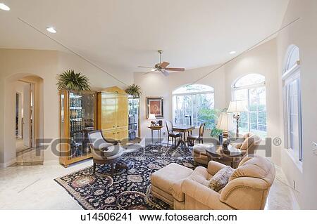 Stock Image - Living room with cabinet and patterned rug. Fotosearch