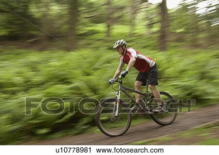 Male cyclist on track in countryside View Large Photo Image Stock Image - Male cyclist on track in countryside. Fotosearch