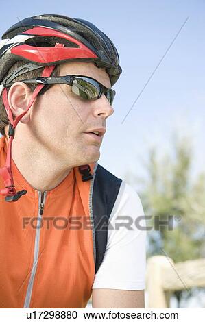 Stock Image - Male cyclist with helmet and sunglasses. Fotosearch