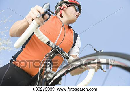 Male cyclist with metallic wheel rims View Large Photo Image Stock Photo - Male cyclist with metallic wheel rims. Fotosearch