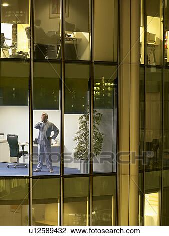 Male surgeon standing in office, view from building exterior View Large Photo Image Stock Image - Male surgeon standing in office, view from building exterior. Fotosearch