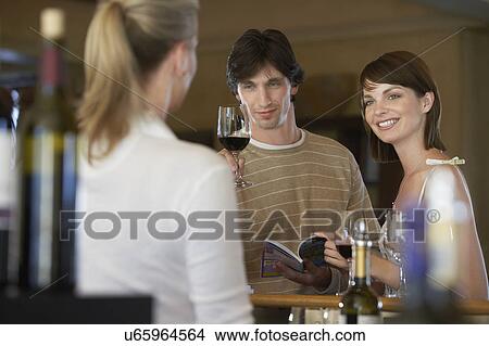 Man and woman wine-tasting, selective focus View Large Photo Image Picture - Man and woman wine-tasting, selective focus. Fotosearch