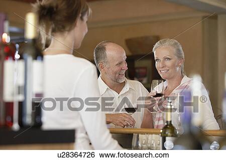 Man and woman wine-tasting, selective focus View Large Photo Image Stock Photograph - Man and woman wine-tasting, selective focus. Fotosearch