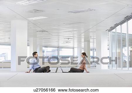 Man and Woman with Laptops in Empty Office Space View Large Photo Image Stock Photograph - Man and Woman with Laptops in Empty Office Space. Fotosearch