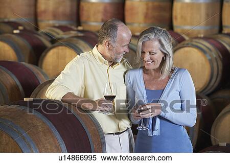 Man and woman with wine-glass aside wine casks View Large Photo Image Stock Photography - Man and woman with wine-glass aside wine casks. Fotosearch