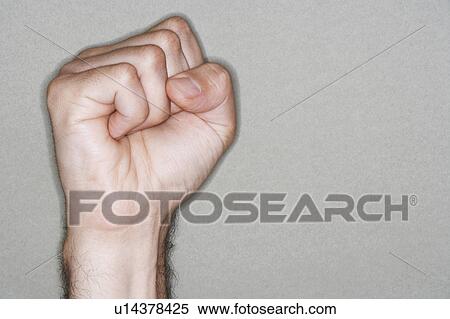 Man holding up clenched fist, close-up on hand View Large Photo Image Stock Photography - Man holding up clenched fist, close-up on hand. Fotosearch