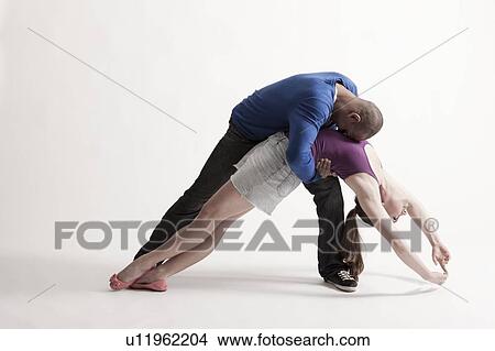 Man holds modern dance partner in position of loss View Large Photo Image Picture - Man holds modern dance partner in position of loss. Fotosearch