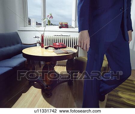 Stock Image - Man in Suit Walking Away from Telephone, low section. Fotosearch