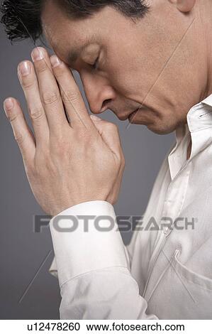 Man in white shirt praying, close-up, profile View Large Photo Image Stock Image - Man in white shirt praying, close-up, profile. Fotosearch