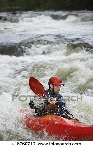 Man kayaking in river View Large Photo Image Stock Photo - Man kayaking in river. Fotosearch
