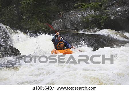 Stock Photo - Man kayaking in river. Fotosearch