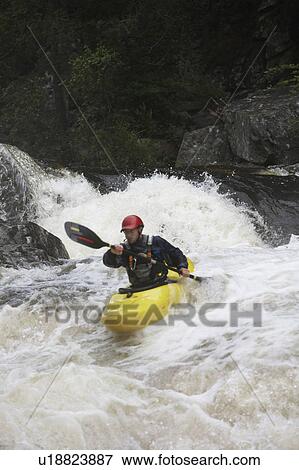 Stock Photo - Man kayaking in river. Fotosearch