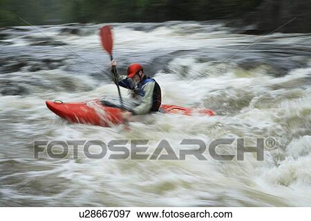 Man kayaking in river View Large Photo Image Stock Photo - Man kayaking in river. Fotosearch