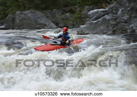 Stock Photograph - Man kayaking in river. Fotosearch