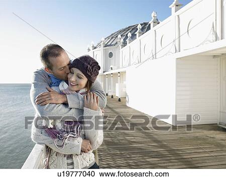 Man kissing woman, standing on pier, half length View Large Photo Image Stock Image - Man kissing woman, standing on pier, half length. Fotosearch