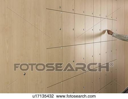 Stock Image - Man Opening Post Office Box. Fotosearch