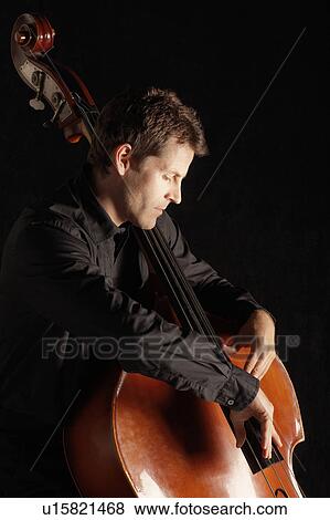 Man Playing Double Bass, side view View Large Photo Image Stock Photo - Man Playing Double Bass, side view. Fotosearch