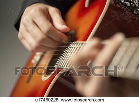 Stock Photo - Man Playing Guitar, detail, close-up. Fotosearch