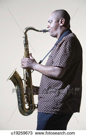 Stock Image - Man Playing Saxophone, side view. Fotosearch