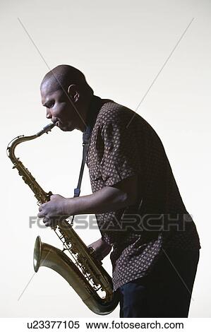 Stock Photography - Man Playing Saxophone, side view. Fotosearch