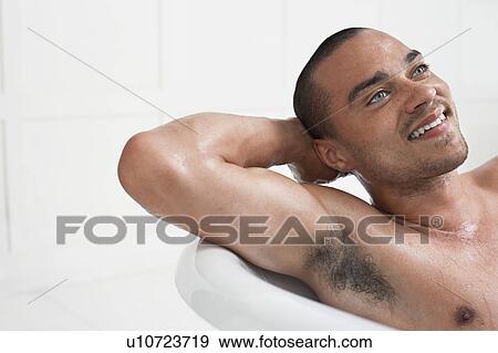 Stock Photo - Man relaxing in bathtub. Fotosearch