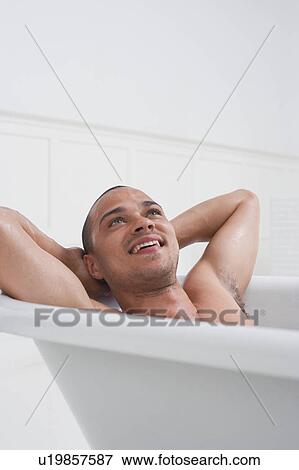 Stock Photo - Man relaxing in bathtub. Fotosearch