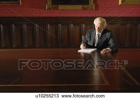 Man sitting in Board Room, writing View Large Photo Image Stock Image - Man sitting in Board Room, writing. Fotosearch