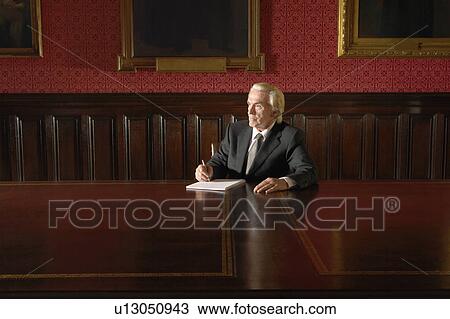 Man sitting in Board Room, writing View Large Photo Image Stock Image - Man sitting in Board Room, writing. Fotosearch