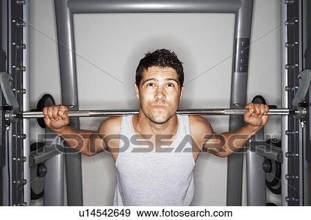 Man struggling to lift Weights on weight machine View Large Photo Image Stock Photo - Man struggling to lift Weights on weight machine. Fotosearch