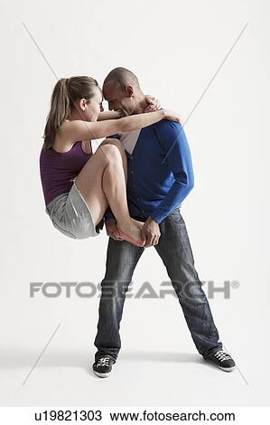 Stock Image - Man supports modern dance partner with barefeet. Fotosearch