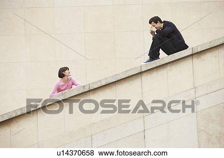Man taking photograph of woman on stairway View Large Photo Image Stock Photo - Man taking photograph of woman on stairway. Fotosearch