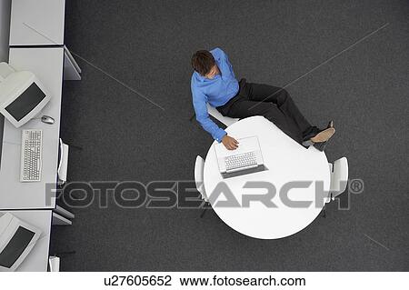 Man Using Laptop in computer room, overhead view View Large Photo Image Stock Image - Man Using Laptop in computer room, overhead view. Fotosearch