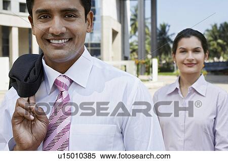 Stock Photography - Man wearing hard hat in city. Fotosearch