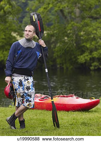 Man with kayak paddle by river View Large Photo Image Stock Photo - Man with kayak paddle by river. Fotosearch