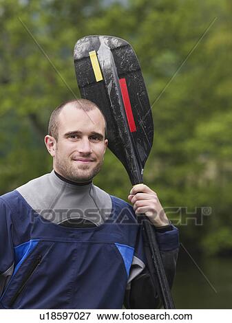 Man with kayak paddle, outdoors, portrait View Large Photo Image Stock Photo - Man with kayak paddle, outdoors, portrait. Fotosearch
