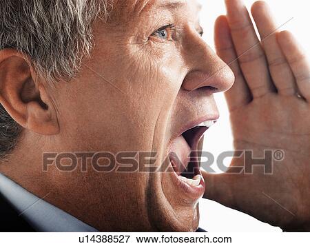 Stock Photo - Man yelling, side view close-up. Fotosearch
