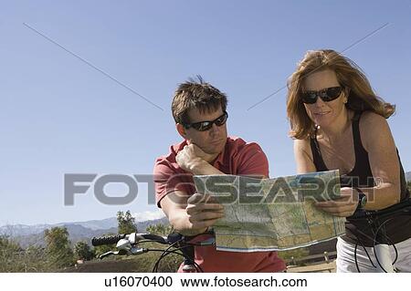 Mature couple on cycling holiday map reading View Large Photo Image Stock Image - Mature couple on cycling holiday map reading. Fotosearch