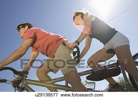 Stock Photo - Mature couple on tandem bicycle. Fotosearch