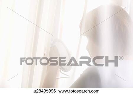Mature woman looks at reflection in hand mirror View Large Photo Image Stock Photograph - Mature woman looks at reflection in hand mirror. Fotosearch