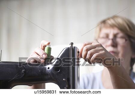 Mature woman threads sewing machine View Large Photo Image Stock Image - Mature woman threads sewing machine. Fotosearch