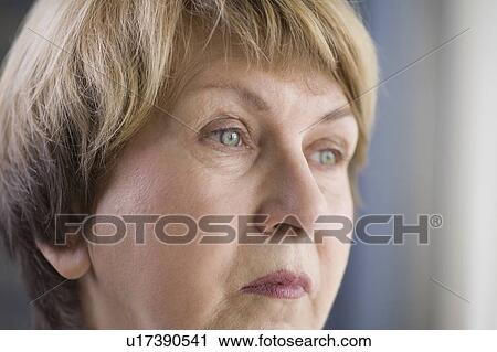 Stock Image - Mature woman with downturned mouth. Fotosearch