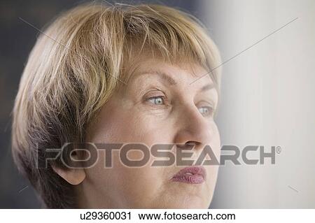 Stock Image - Mature woman with downturned mouth. Fotosearch