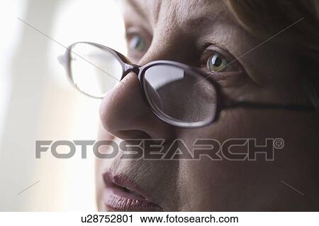 Mature woman with reading glasses View Large Photo Image Stock Image - Mature woman with reading glasses. Fotosearch