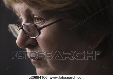 Mature woman with reading glasses View Large Photo Image Stock Photograph - Mature woman with reading glasses. Fotosearch