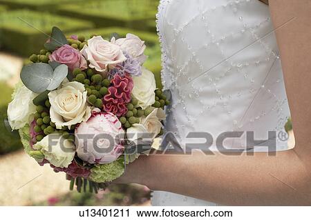 Mid adult woman, holding bouquet, mid section, side view, close-up View Large Photo Image Stock Image - Mid adult woman, holding bouquet, mid section, side view, close-up. Fotosearch