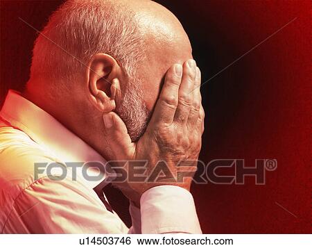 Stock Photograph - Middle Aged Businessman with head in hands, profile. Fotosearch